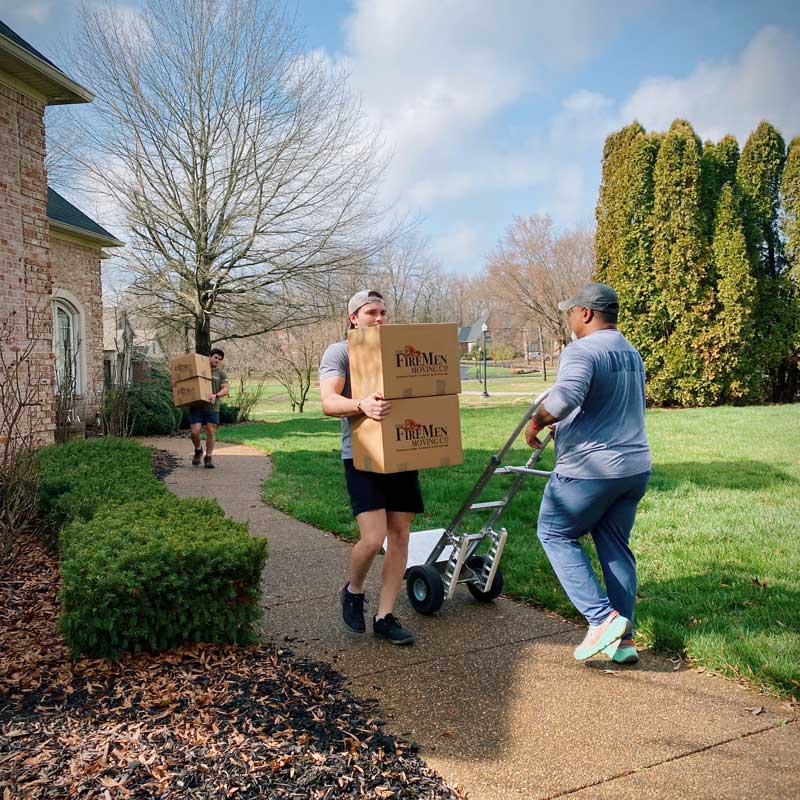movers carrying boxes out of a residential home